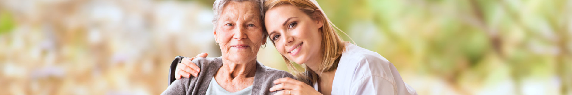 caregiver and elder woman smiling