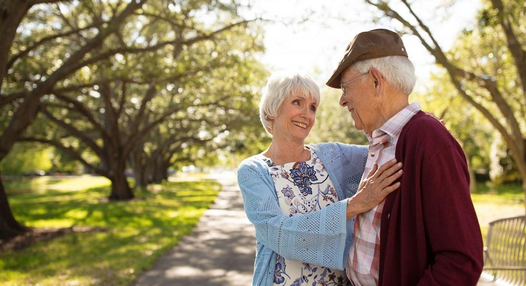 caregiver and elder woman smiling to each other