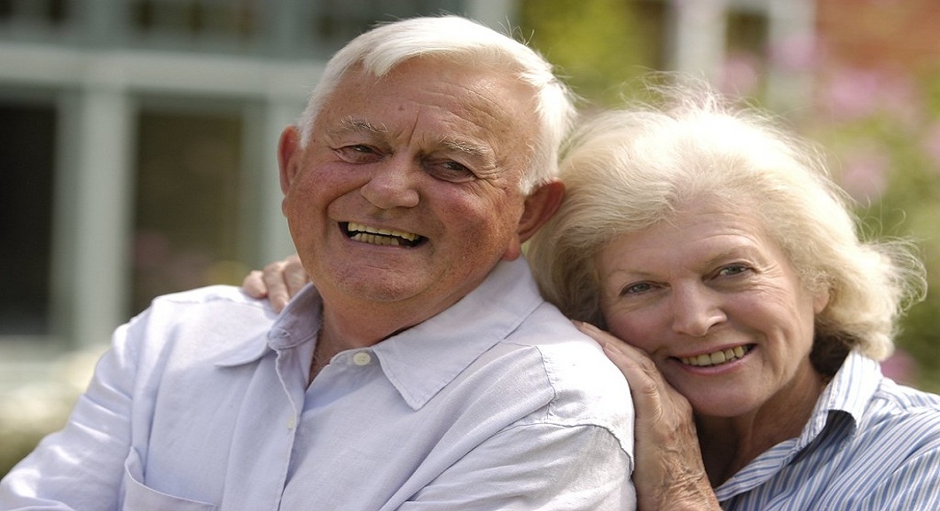 caregiver and elder woman smiling to each other